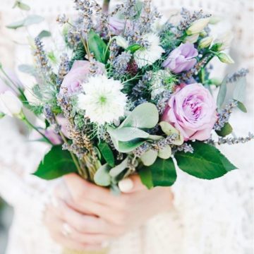 Wedding bouquet consists of lavender, lilac roses, lisianthus, mattiola, nigella, lisianthus, eucalyptus.