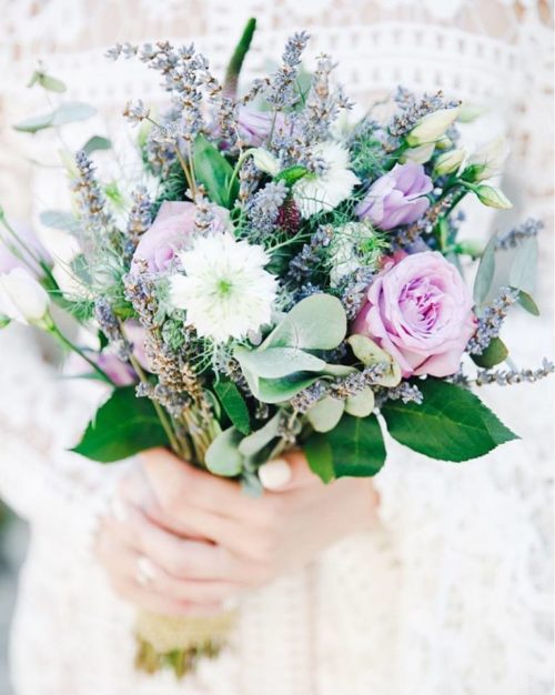 Wedding bouquet consists of lavender, lilac roses, lisianthus, mattiola, nigella, lisianthus, eucalyptus.