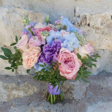 Delicate bouquet of peonies, lisianthus, delphinium, roses, trachelium, matiola.