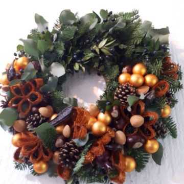 The wreath is made up of spruce branches canadian blue spruce, Christmas decorations, cotton, dried flowers.
