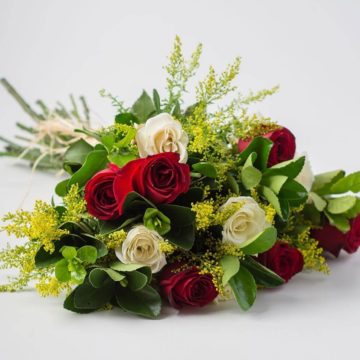 The classic bouquet is composed of 11 red and white roses, solidago, greenery