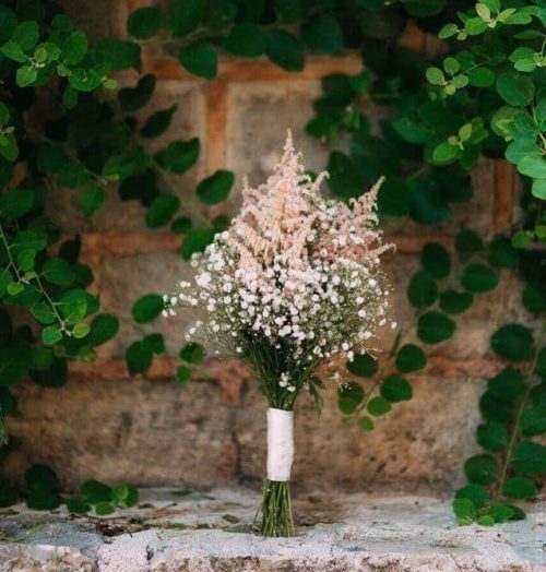 Delicate bouquet of pink astilba and white gypsophila.
