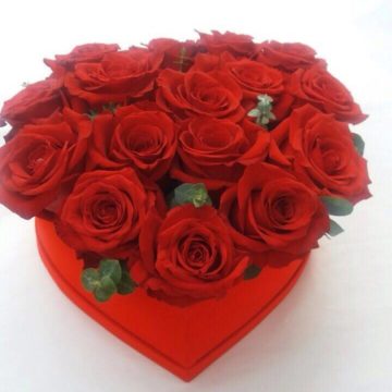 Red roses in a heart shaped box.